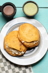 Chicharron gorditas with cheese on turquoise background. Mexican food