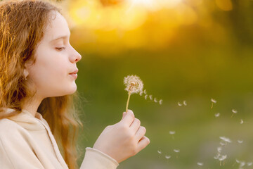 Little girl blowing dandelion. in spring park. Medical, healthy concept.