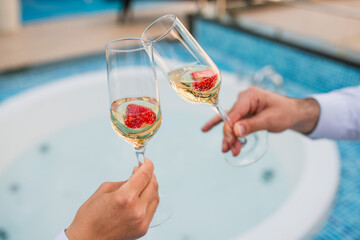 Summer vacations concept image. two glass of cool champagne wine with a plate of strawberries...