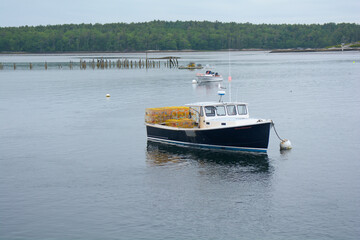 Lobster boat along the Maine coast in a bay of the Atlantic Ocean © Jason