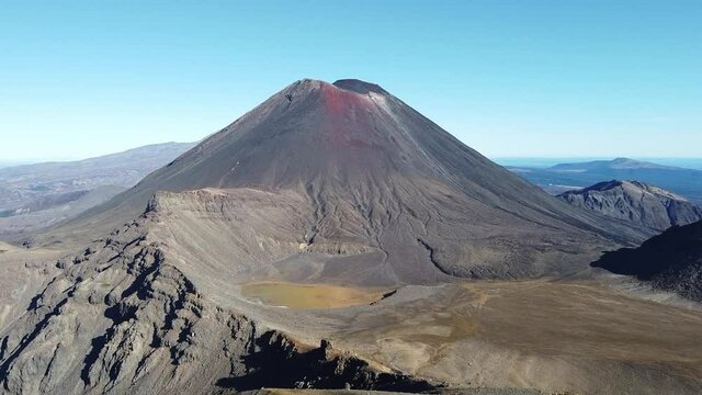 Drone flight to Mount Ngauruhoe from Mount Tongariro with blue sky in the background