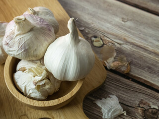 The garlic on wood table for food or cooking concept.