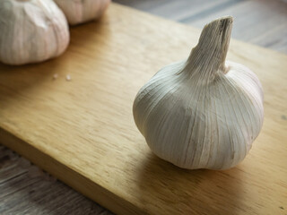 The garlic on wood table for food or cooking concept.