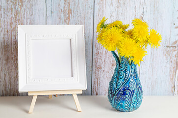 Dandelion bouquet in a vase and picture frame with copy space for mockup