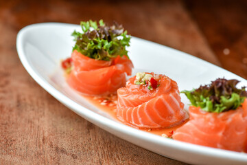Close up Thai spicy salmon salad , mixed vegetable and herb