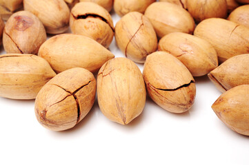 Peeled pecan nuts closeup, isolated on white background