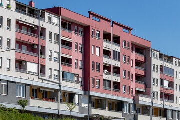 Fragment of a modern residential building, balconies and windows on the sunny side