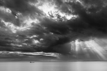 Black-and-white photo of a ship at sea after a thunderstorm and a gloomy sky
