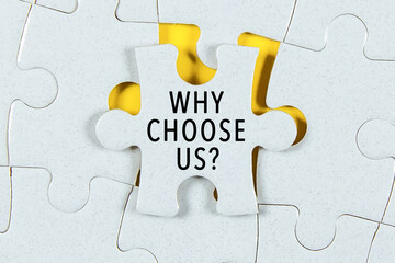 Why Choose Us text on a Jigsaw Puzzle - business concept