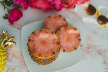 slices of pink pineapple on a plate with flowers