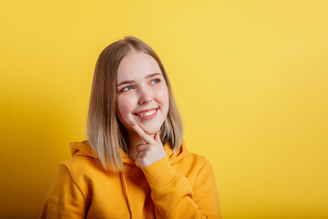 Happy smiling young woman think thought. Portrait of emotional teenage girl looking on empty space...