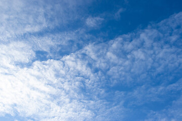 The blue sky during the day with the clouds spreading across the sky.