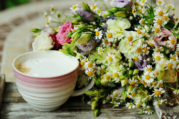 A cup of coffee with flowers