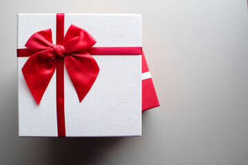 Valentine present. Gift box and red ribbon for romantic couple.Gift box and ribbon with tag for valentine present