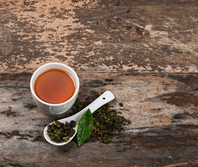 Tae cup and dry leaf on a background