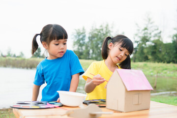 Asian sibling children drawing and painting colouring on the paper