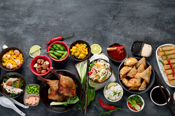 Assorted Chinese dishes and snacks on dark gray background. Traditional food concept.