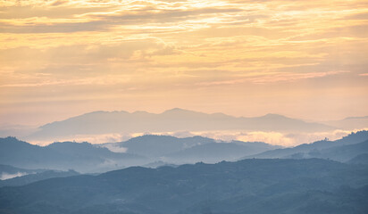 Surreal landscape of morning foggy..Morning clouds at sunrise.Landscape of fog and mountains of...