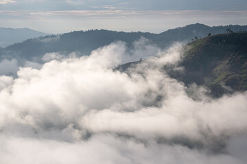 Naklejka na ściany i meble Surreal landscape of morning foggy..Morning clouds at sunrise.Landscape of fog and mountains of northern Thailand.