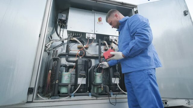 The technician repair electronic temperature sensors with an electronic soldering iron