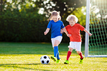 Kids play football. Child at soccer field. © famveldman