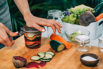 Woman Holding a Jar with Fermented Vegetables.