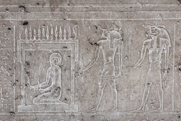 Ancient engraved drawing on the grey tomb wall.