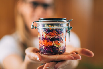 Woman Holding a Jar with Fermented Vegetables.