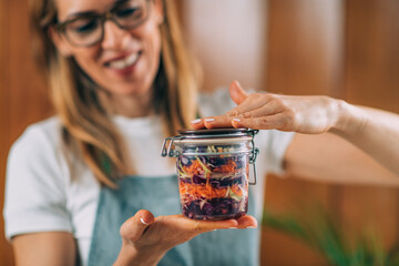 Woman Holding a Jar with Fermented Vegetables.