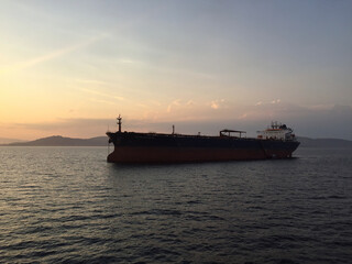 Oil tankers and cargo ships anchored in the roadstead Saronic Gulf at the entrance of the port of Piraeus, Greece.