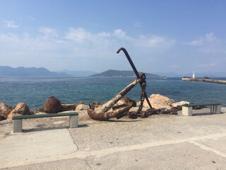 A rusty anchor on the pier at the entrance to the Aegina Marina on Aegina Island, Greece