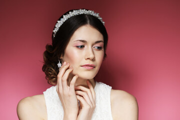 Wedding Hairstyle. Beautiful fashion bride girl model portrait. Luxury jewelry. Attractive young woman with dark hair.