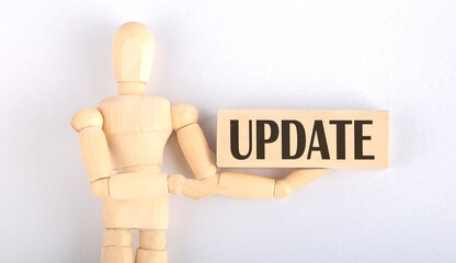 Wooden man shows with a hand to block with text UPDATE