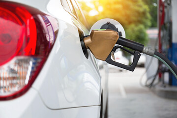 Pumping gasoline fuel in car at gas station.concept Travel,price oil,industrail business and...