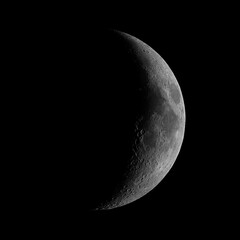 Waxing crescent Moon phase, isolated in the black space, taken with my telescope. © infinitalavita