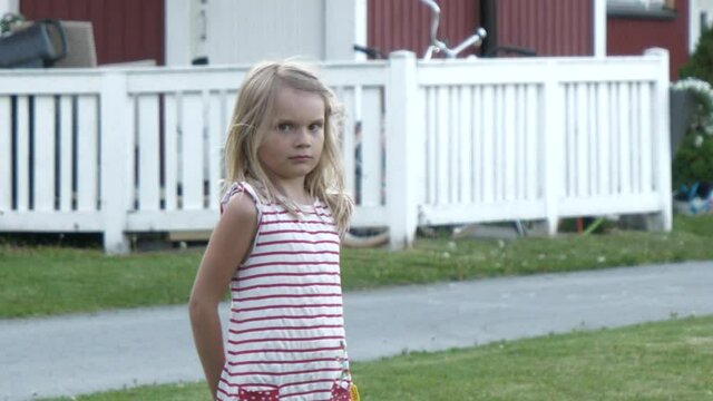 Scandinavian young girl with apartment buildings in background