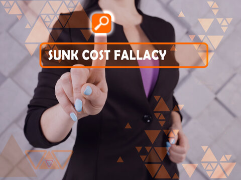  SUNK COST FALLACY inscription on the screen. Businessman hands holding black smart phone.
