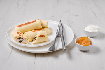 Thin pancakes stuffed with curd and raisins