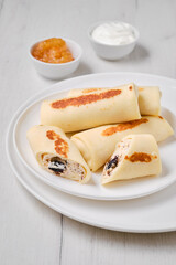 Thin pancakes stuffed with curd and raisins