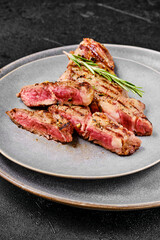 Closeup view of ribeye steak on a plate.