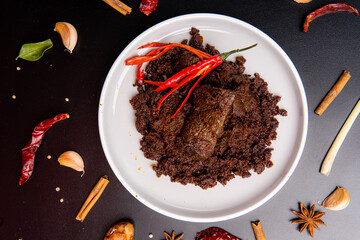 Beef Rendang is a Minang dish originating from the Minangkabau region in West Sumatra, Indonesia.  Rendang has been slow cooked and braised in a coconut milk seasoned with a herb and spice mixture