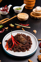 Beef Rendang is a Minang dish originating from the Minangkabau region in West Sumatra, Indonesia.  Rendang has been slow cooked and braised in a coconut milk seasoned with a herb and spice mixture