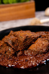 Beef Rendang is a Minang dish originating from the Minangkabau region in West Sumatra, Indonesia.  Rendang has been slow cooked and braised in a coconut milk seasoned with a herb and spice mixture