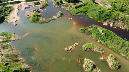 Flooded sand quarry near Sychevo area. Turquoise water pond. Lush green summer landscape for outdoors vacation, swimming. Volokolamsk district of Moscow region. Russia