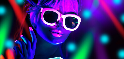 Disco dancer in neon light in night club Fashion model woman in neon light, portrait of beautiful...