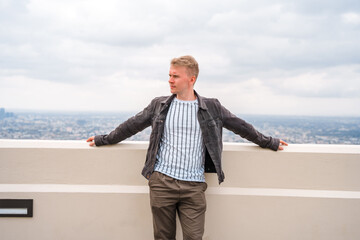A young man enjoys a view of the city from the observation deck at the Griffith Observatory in Los...