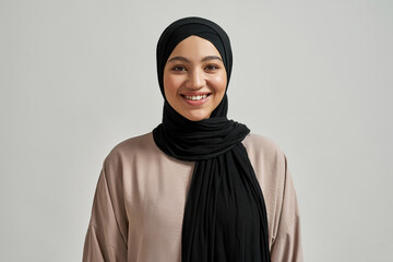 Portrait of smiling young arabic woman in black hijab - obrazy, fototapety, plakaty
