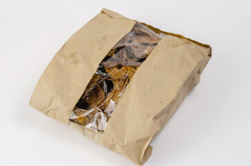 Pet treats in a brown paper bag with a window. Kraft bag with pi