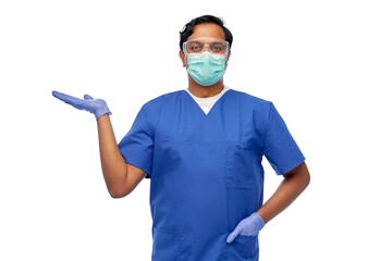Fototapeta na wymiar healthcare, profession and medicine concept - indian doctor or male nurse in face protective medical mask for protection from virus disease holding something imaginary on hand over white background