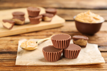 Obraz na płótnie Canvas Delicious peanut butter cups on wooden table